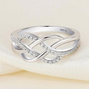 Sterling Silver White Infinity Twist Ring with Pavé Stones